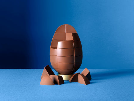 Unpackaged Belgian Milk Chocolate Egg on a rich blue background